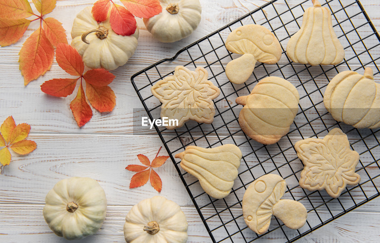 Autumn baking. cookies in the form of pumpkin and leaves on the table. cozy autumn concept.