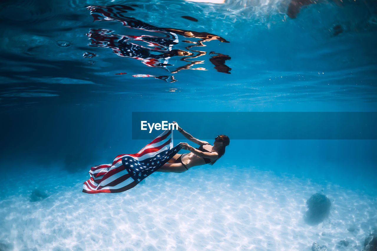 high angle view of woman swimming in sea