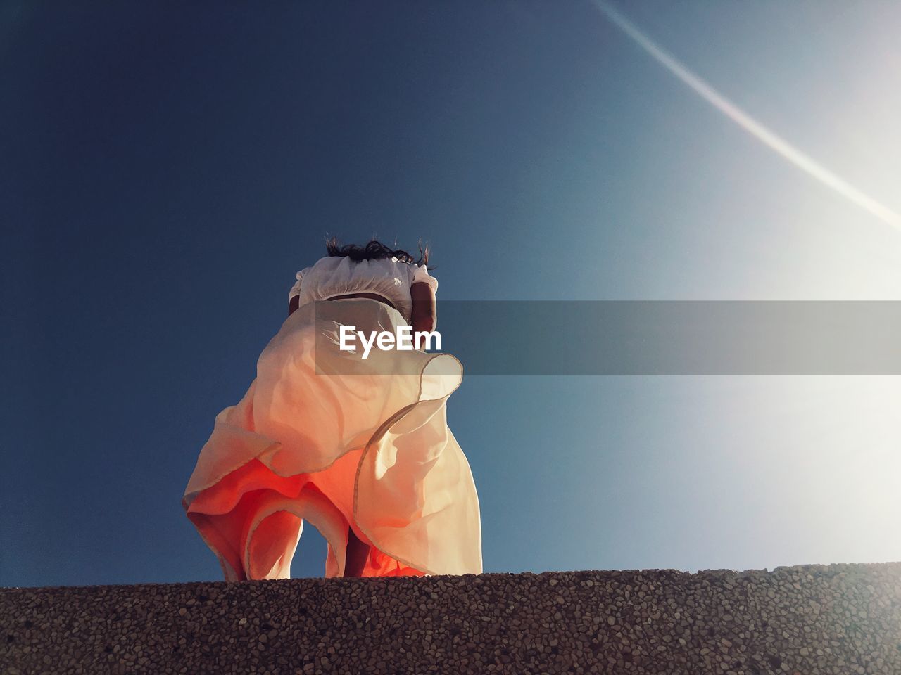 Low angle view of woman against sky