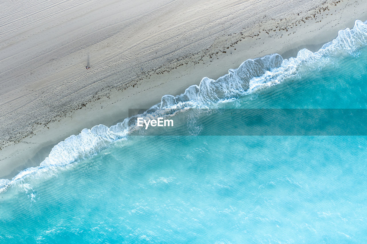 HIGH ANGLE VIEW OF SWIMMING POOL ON BEACH