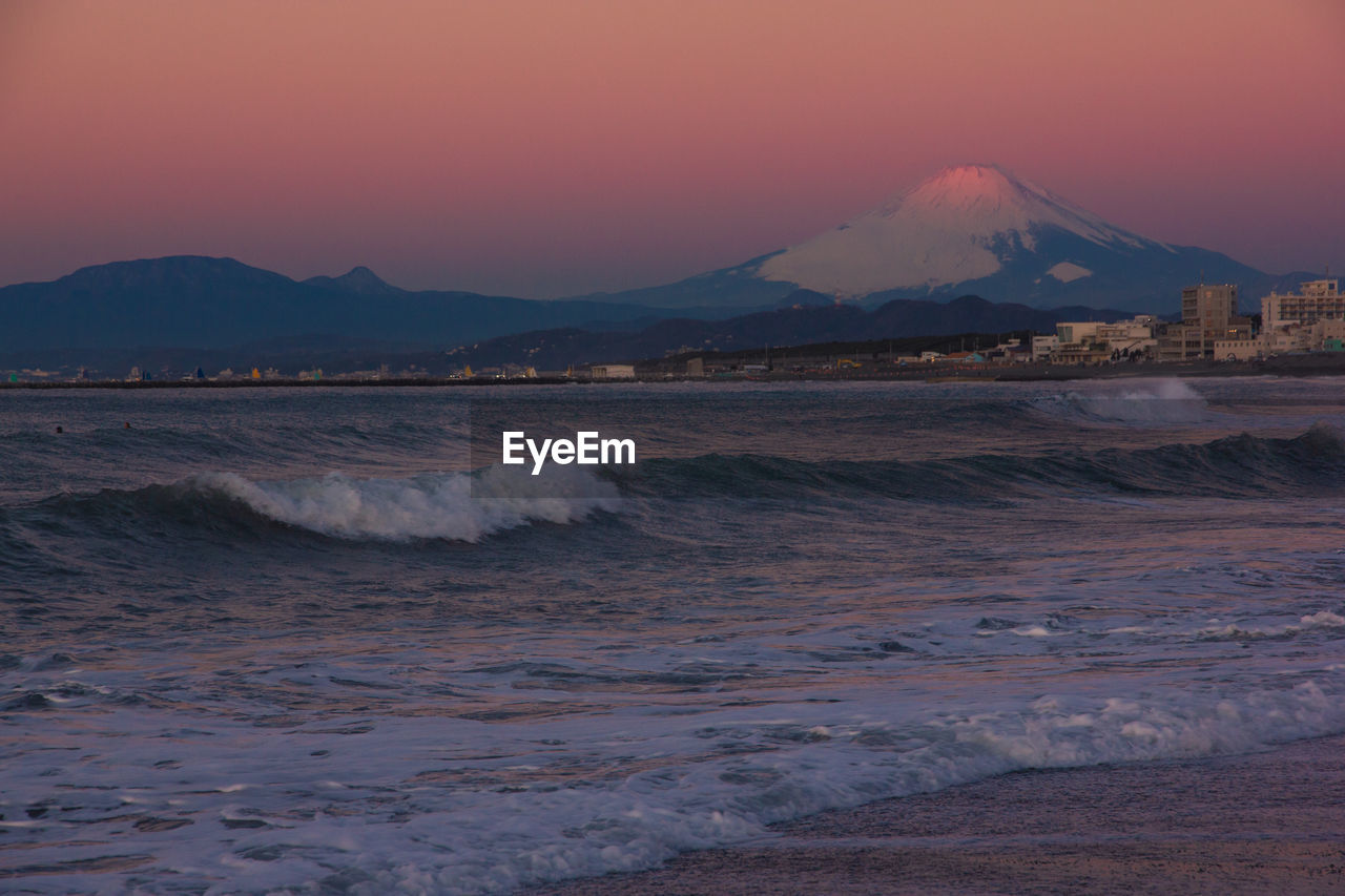 Scenic view of sea and mt.fuji against sky during sunset
