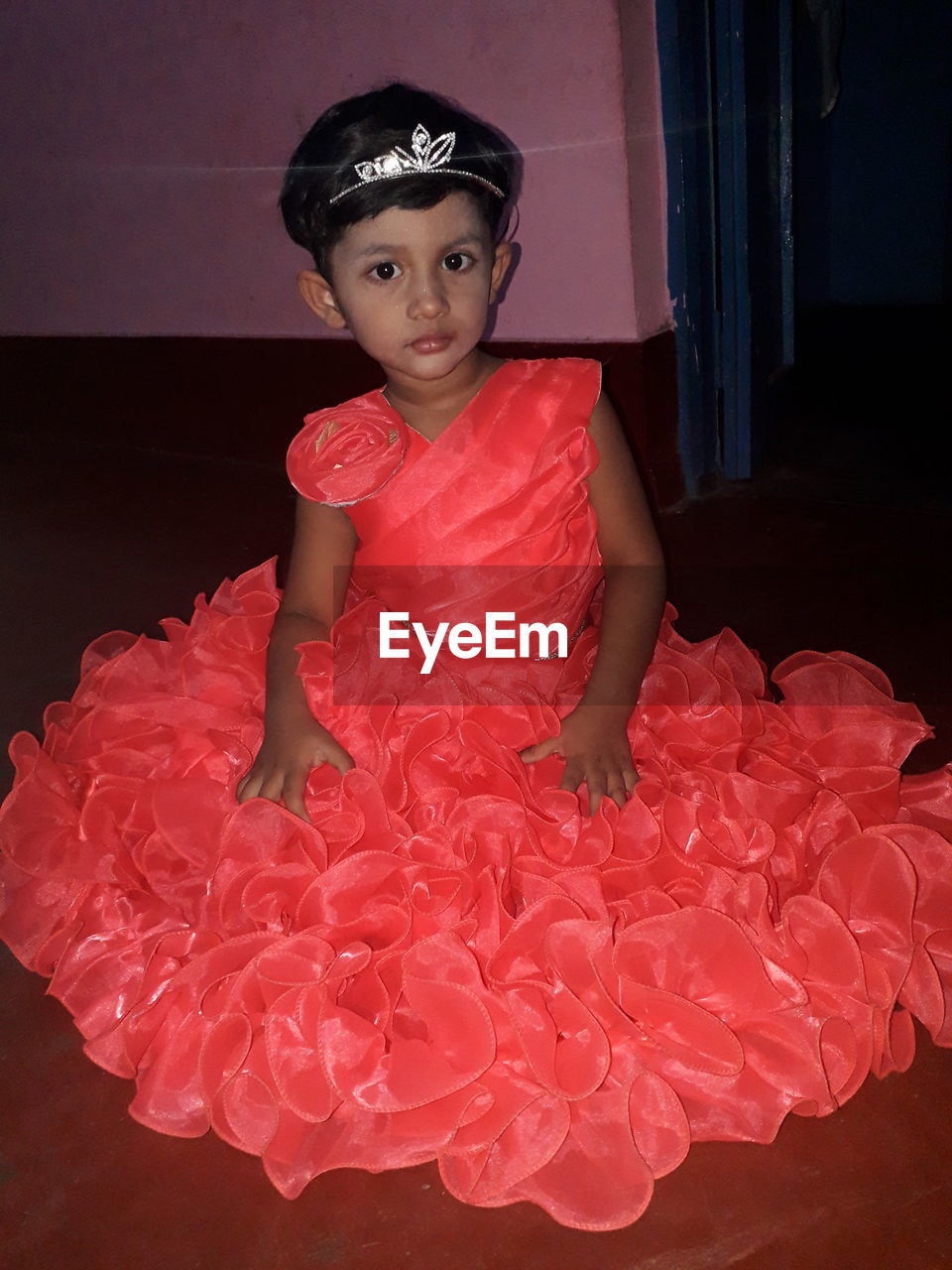 PORTRAIT OF A SMILING GIRL IN RED DRESS