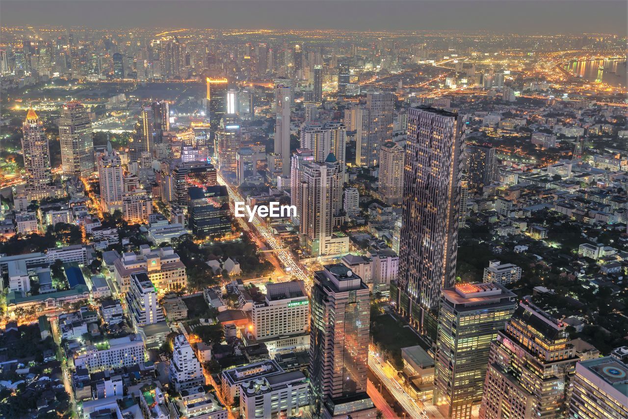 Aerial view of illuminated city buildings at dusk