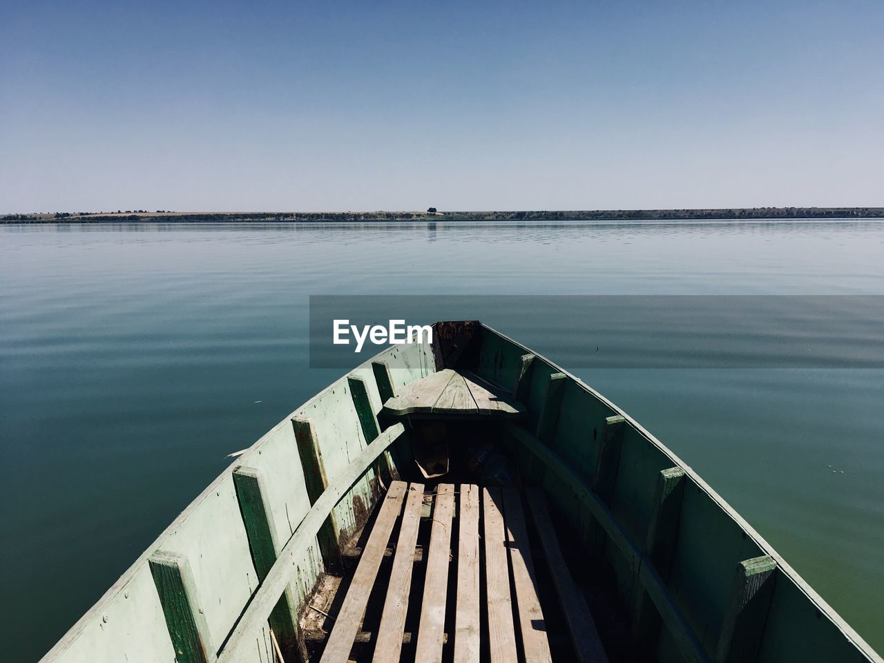 Pier over sea against clear blue sky