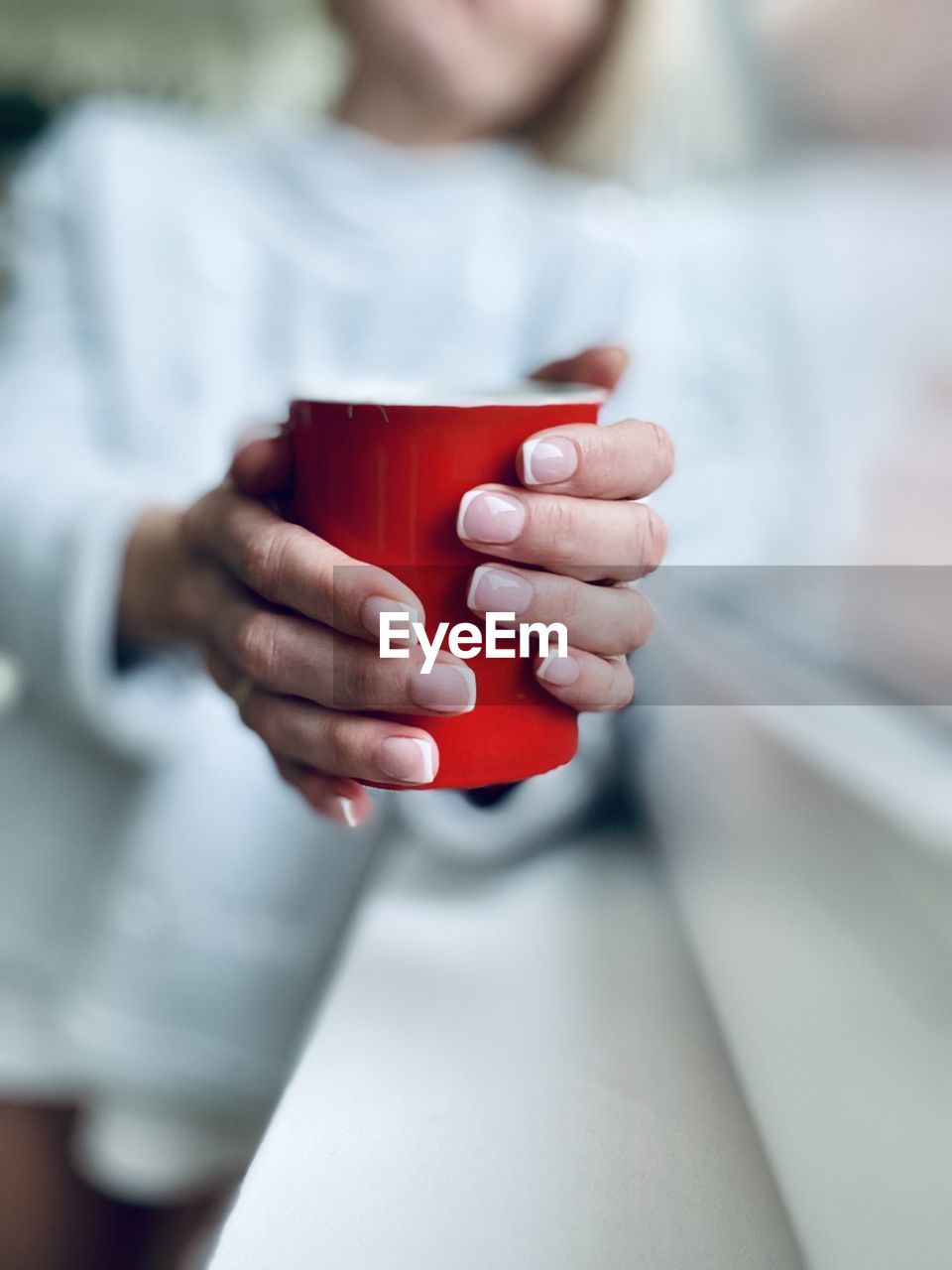 Midsection of man holding coffee cup