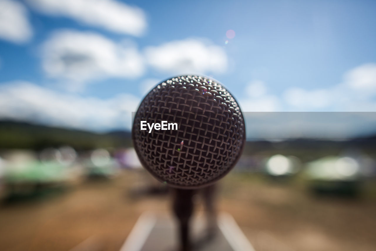 Close-up of microphone against sky