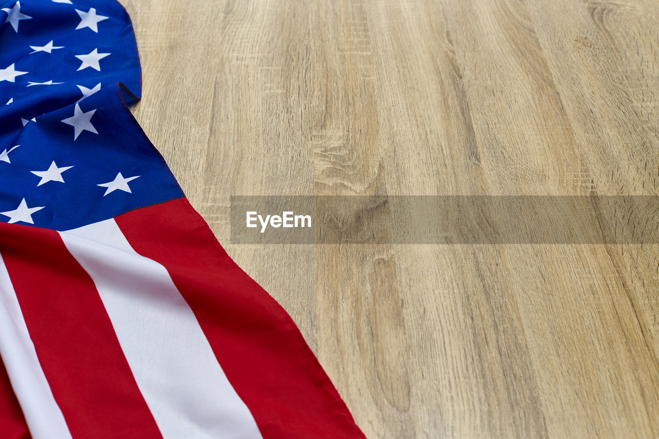 Close-up of american flag on wooden floor