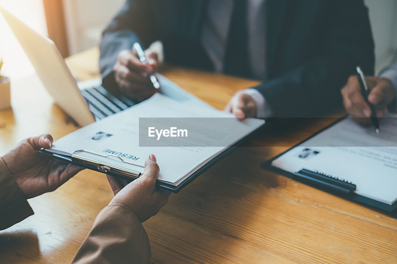 Business people taking job interview at desk in office