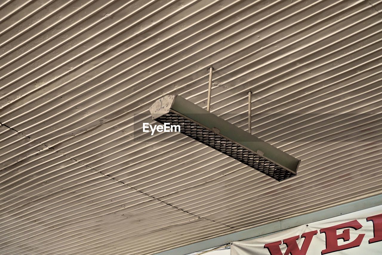 LOW ANGLE VIEW OF INFORMATION SIGN ON WALL OF BUILDING