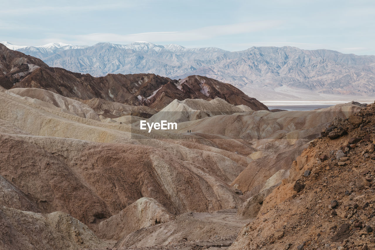 Hikers on the scenic path of death valley's zabriskie point