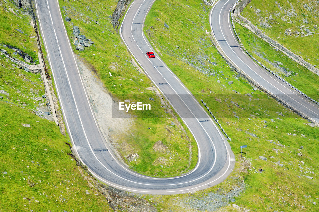 High angle view of red car on winding country road