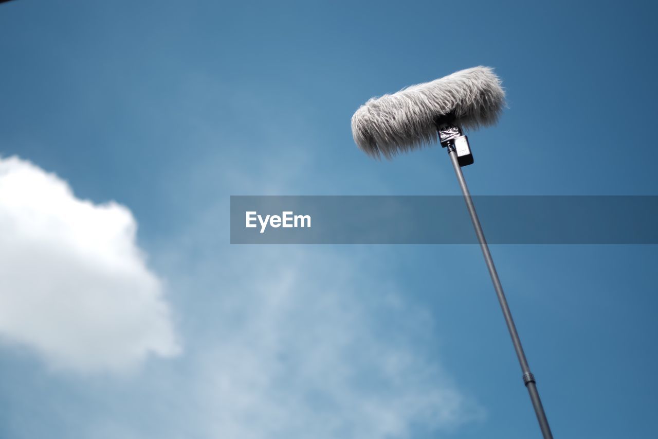 Low angle view of microphone against sky