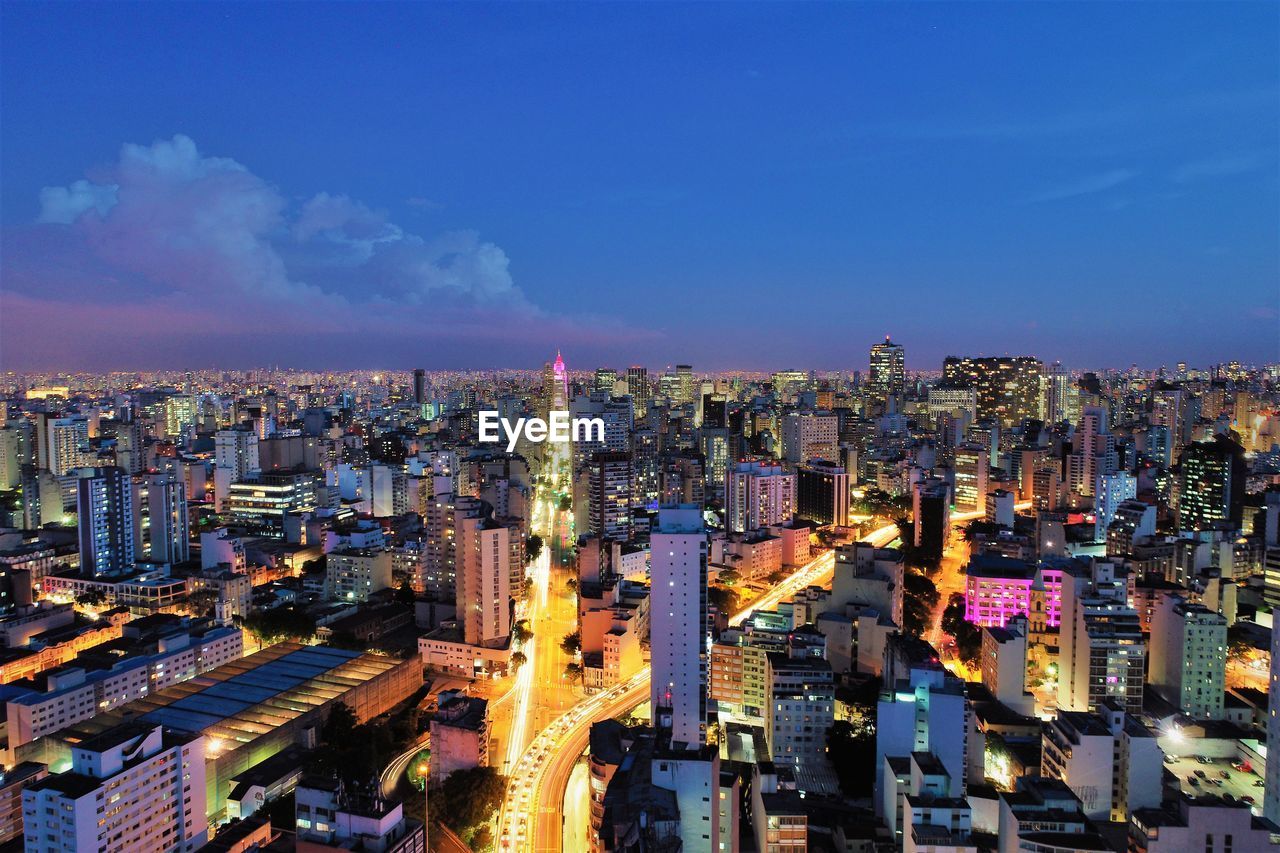 High angle view of illuminated buildings against sky in city