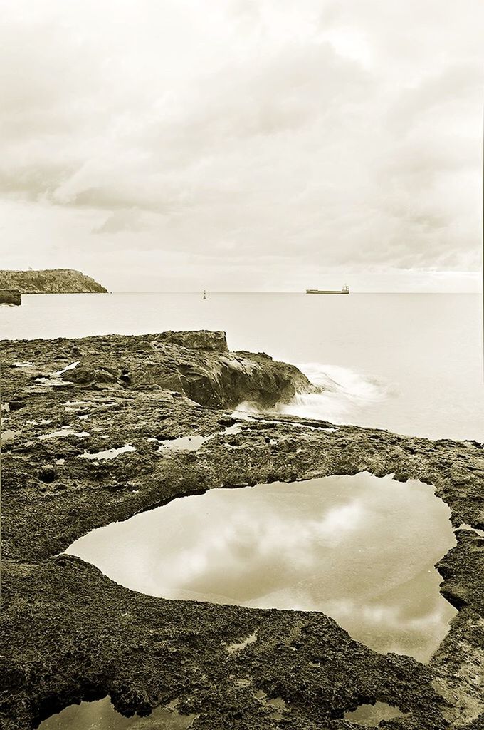 VIEW OF SEA AGAINST CLOUDY SKY