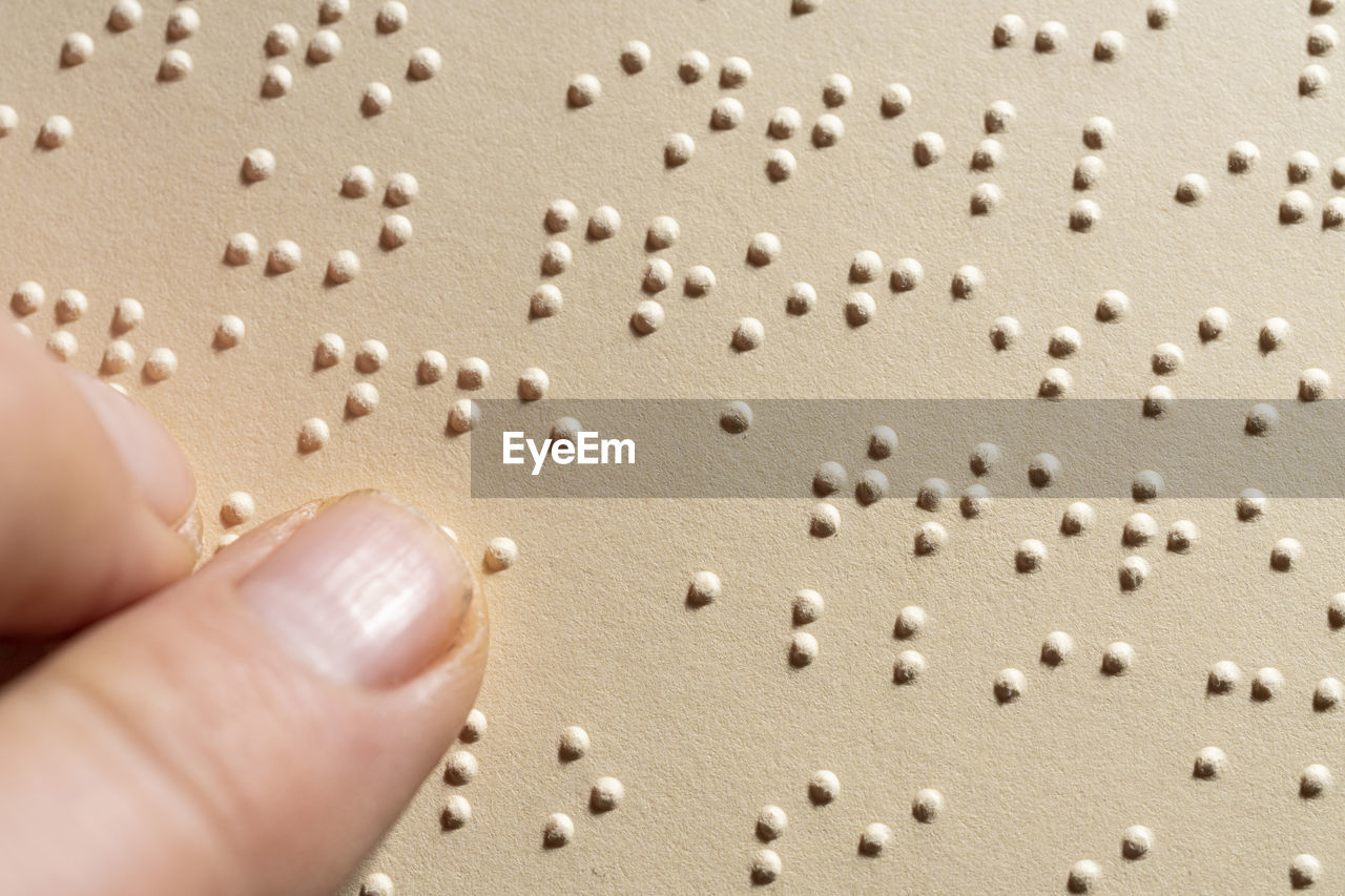 A finger following the reading of a page written in the braille alphabet, 