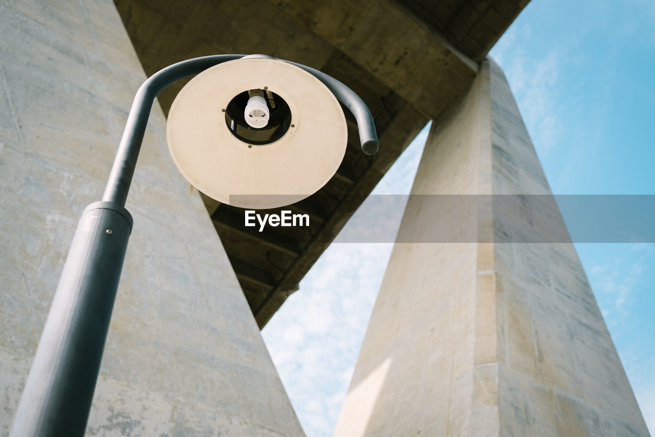 Low angle view of street light against bridge