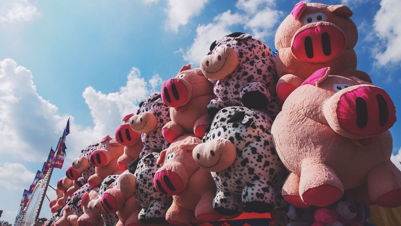 Low angle view of stuffed toys against sky