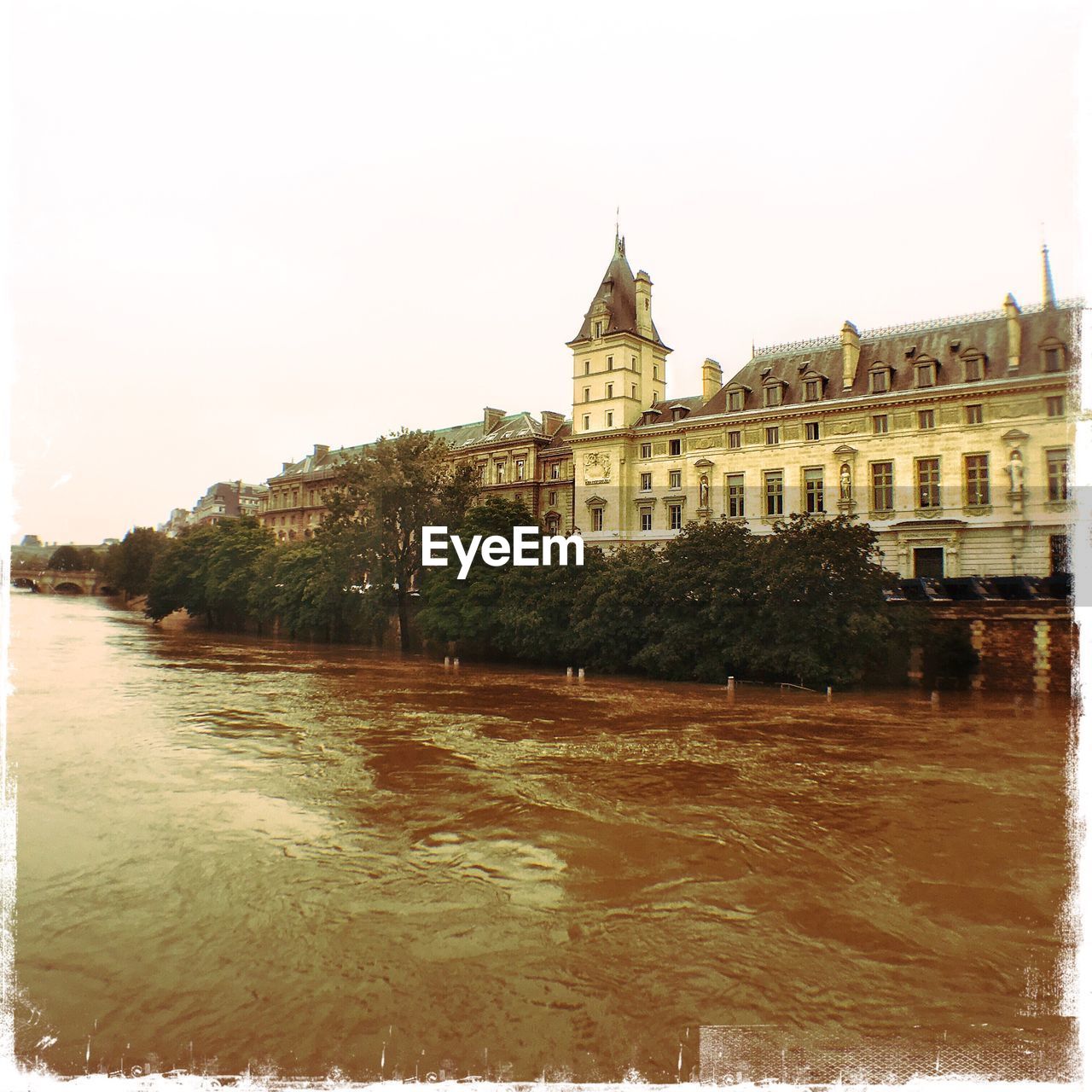 VIEW OF RIVER WITH BUILDINGS IN BACKGROUND