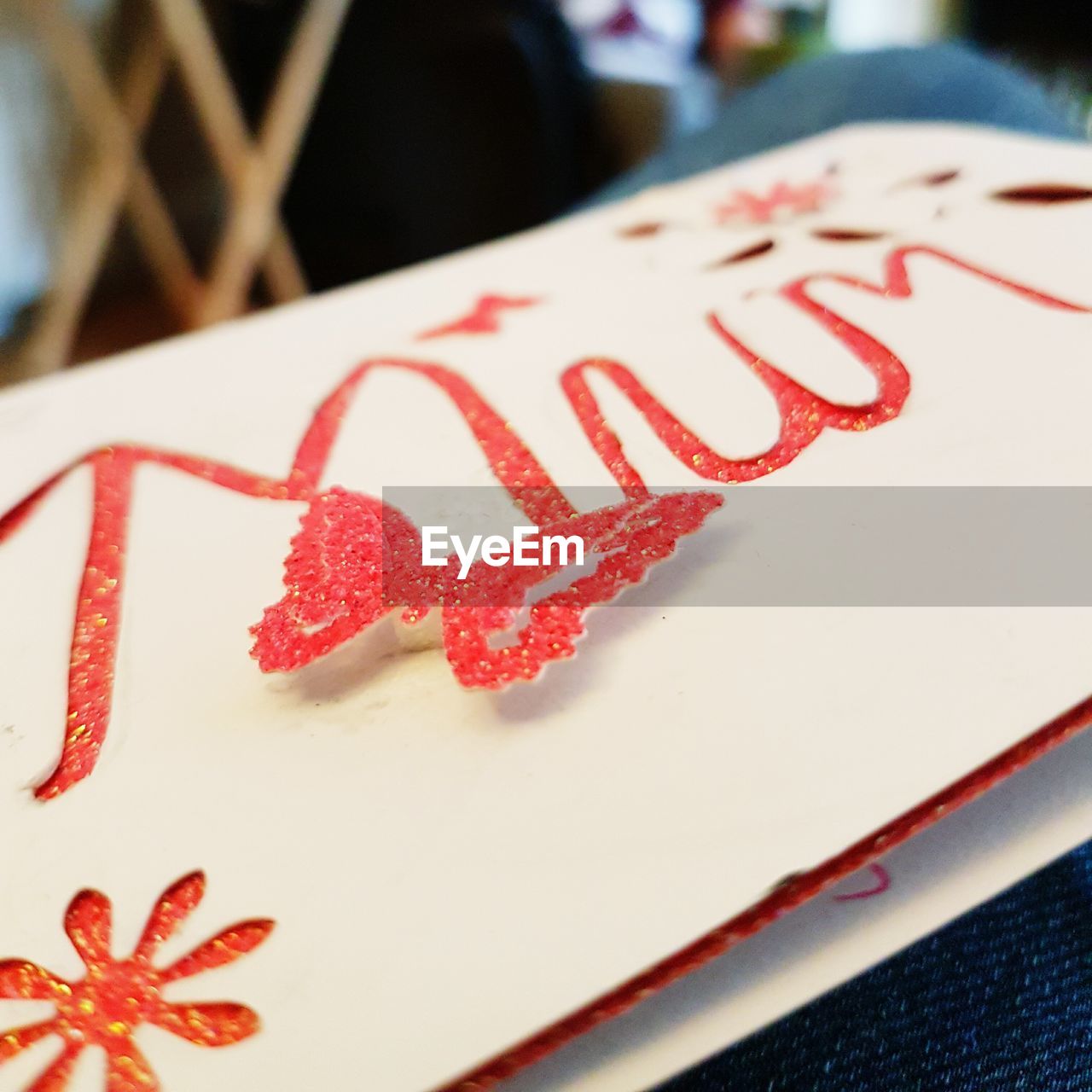 HIGH ANGLE VIEW OF HEART SHAPE TEXT ON RED PAPER