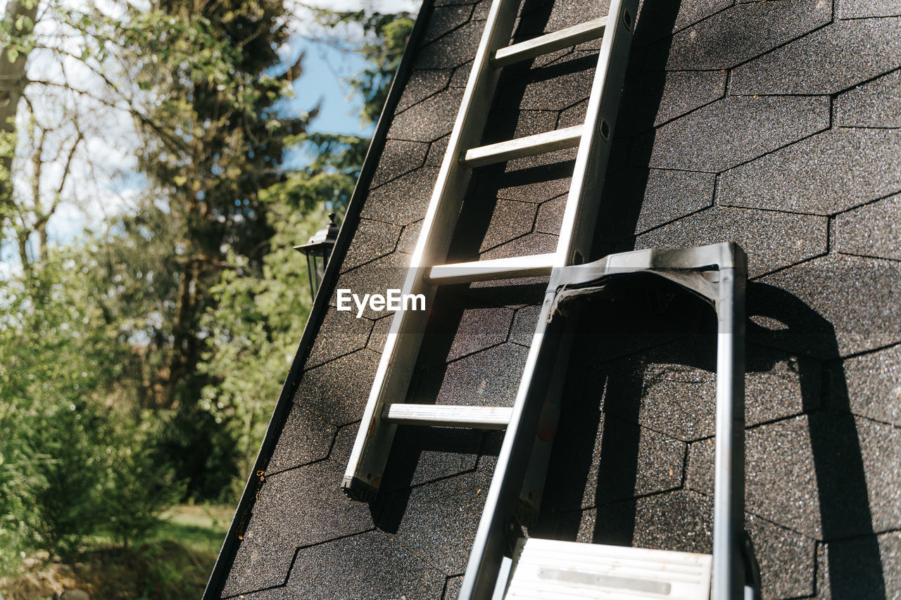 LOW ANGLE VIEW OF LADDER ON BUILDING