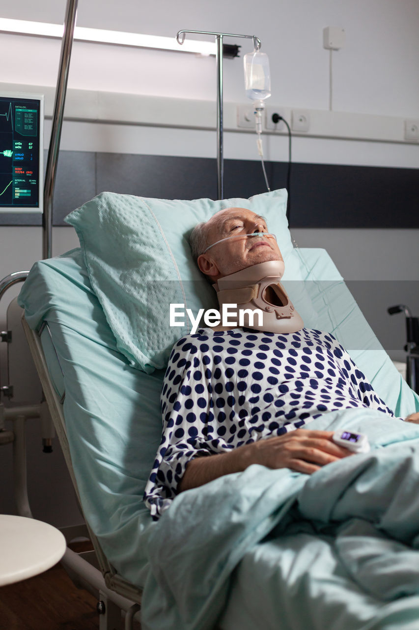 Midsection of man lying on bed