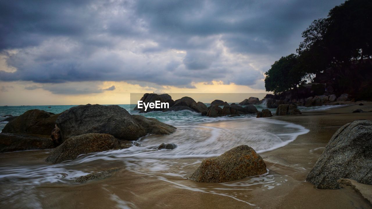 Scenic view of beach against sky during sunset