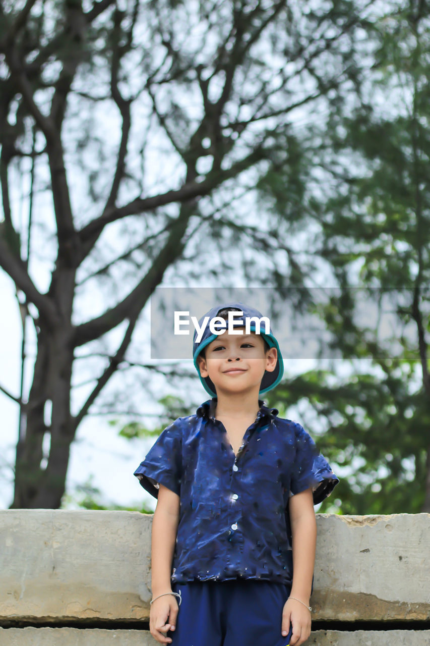 Portrait of boy wearing cap standing outdoors