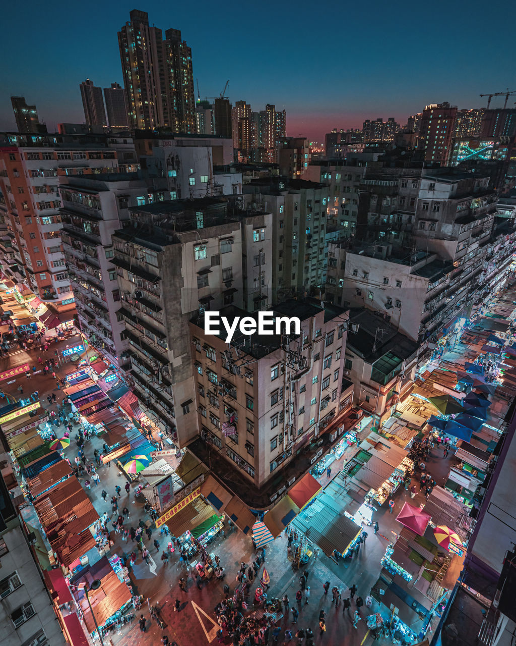 High angle view of illuminated buildings in city at night, sham shui po, hong kong. 