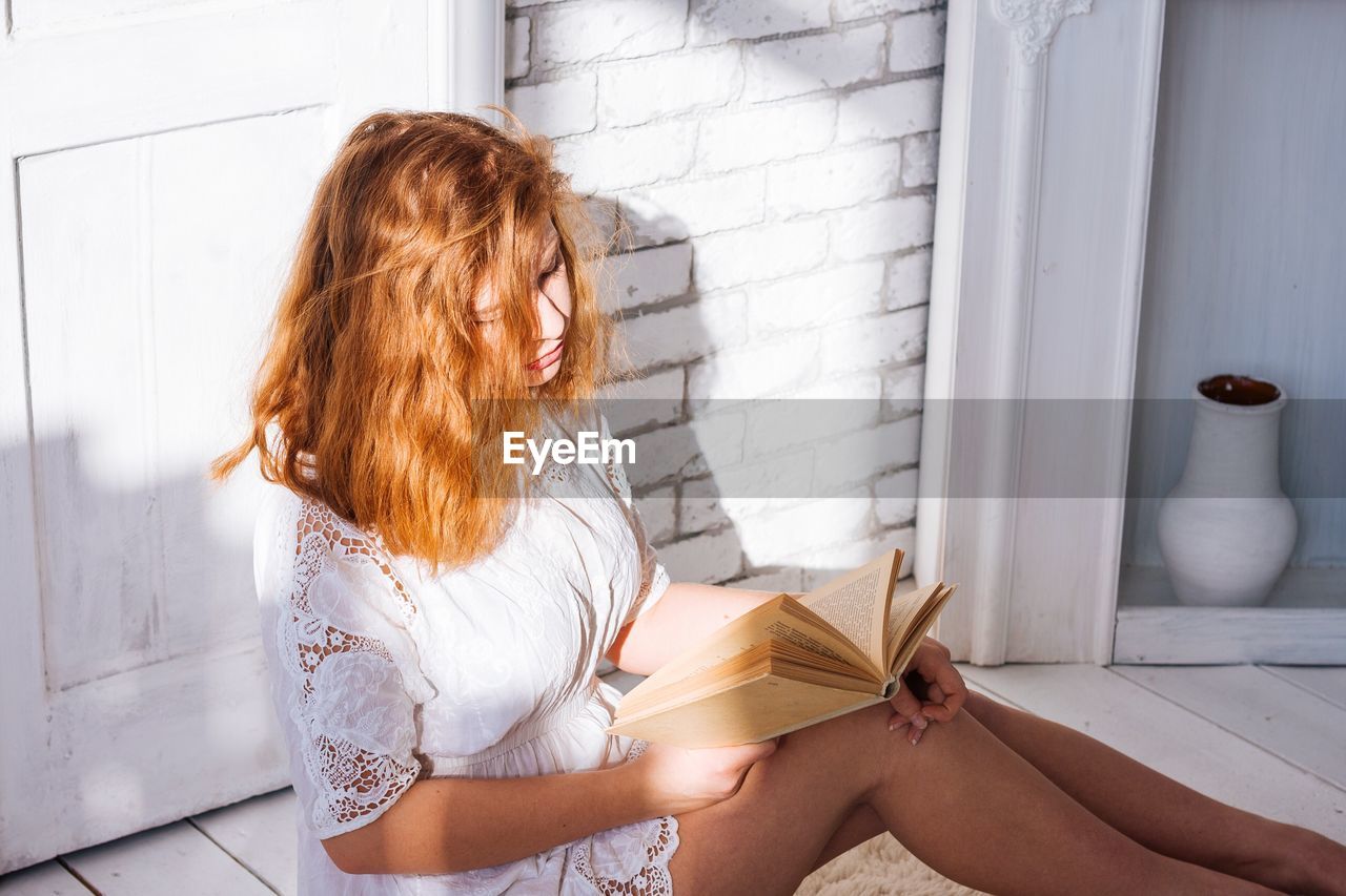 Close-up of woman reading book