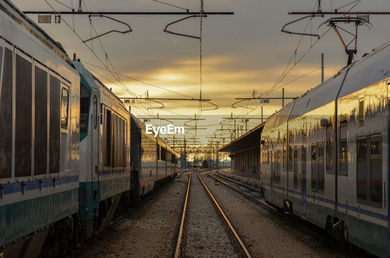 TRAIN ON RAILROAD TRACKS AGAINST SKY