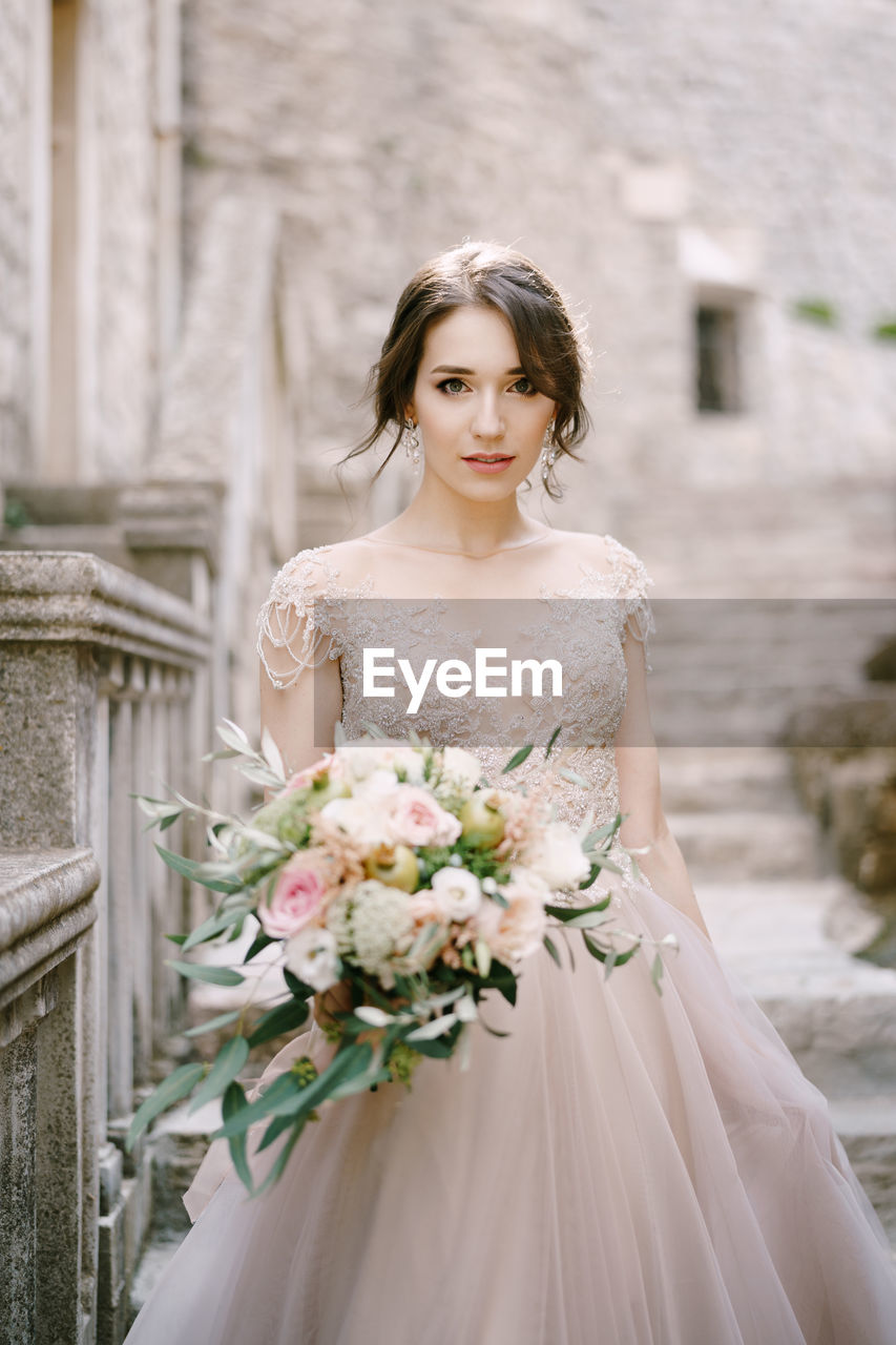 portrait of beautiful young woman standing in traditional clothing