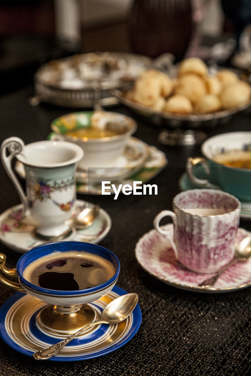 CLOSE-UP OF TEA CUP ON TABLE WITH SPOON