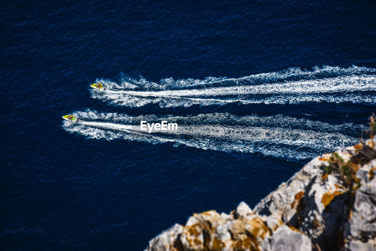 Aerial view of people driving water motorcycles