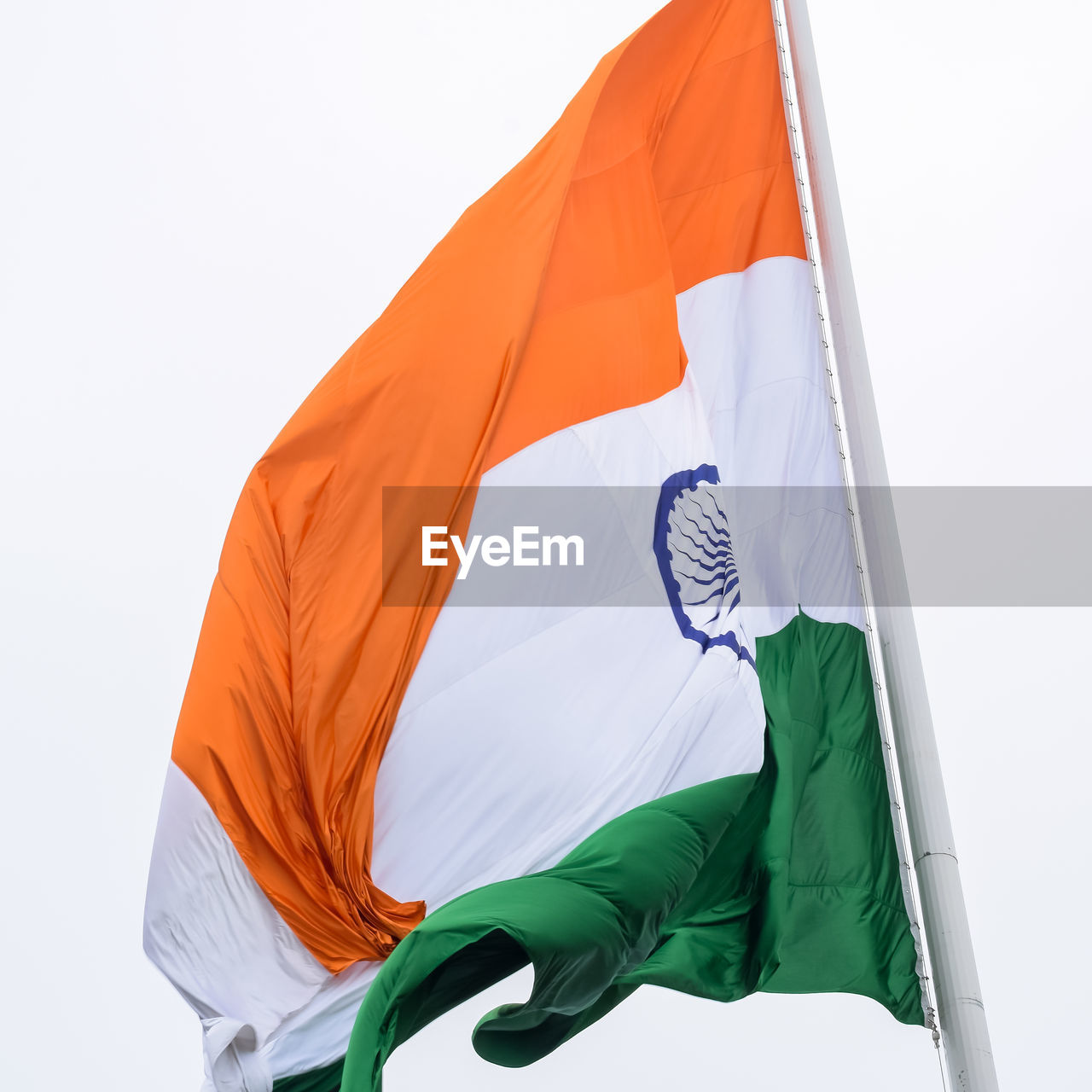 India flag flying high at connaught place with pride in blue sky, india flag fluttering, indian flag