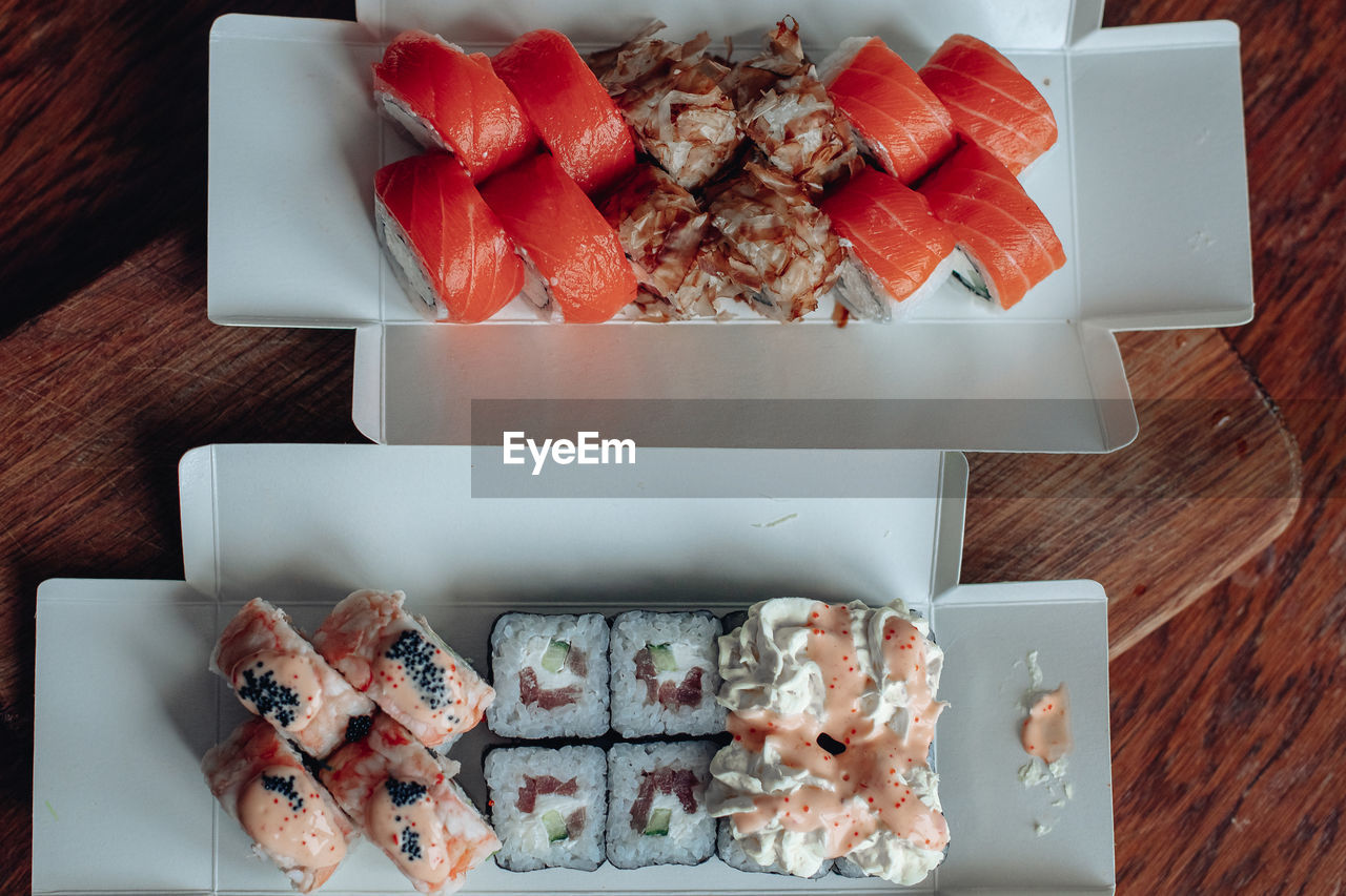 food and drink, food, freshness, healthy eating, table, wood, fruit, high angle view, meal, directly above, wellbeing, no people, indoors, still life, dish, plate, sweet food, berry, slice, strawberry, sushi, dessert, seafood, cuisine
