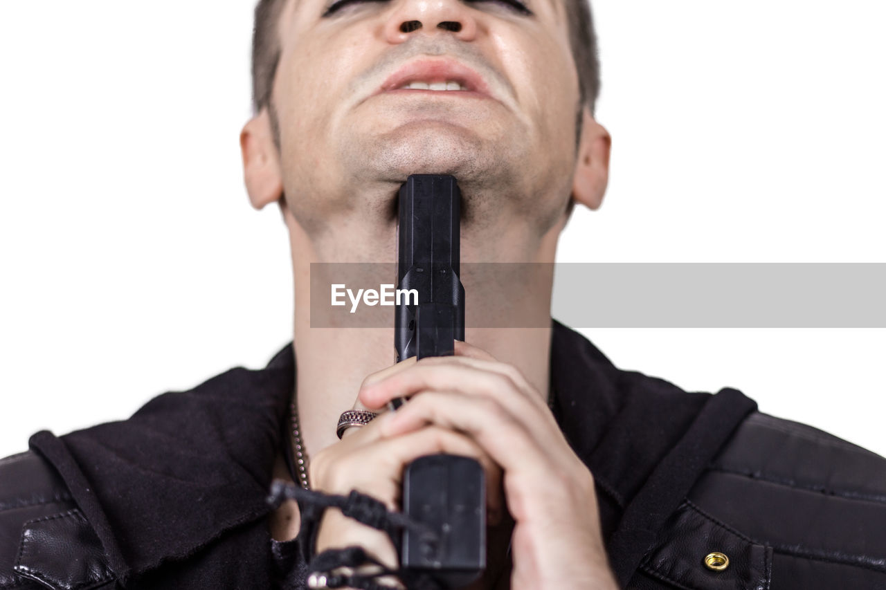 CLOSE-UP PORTRAIT OF YOUNG MAN HOLDING CAMERA