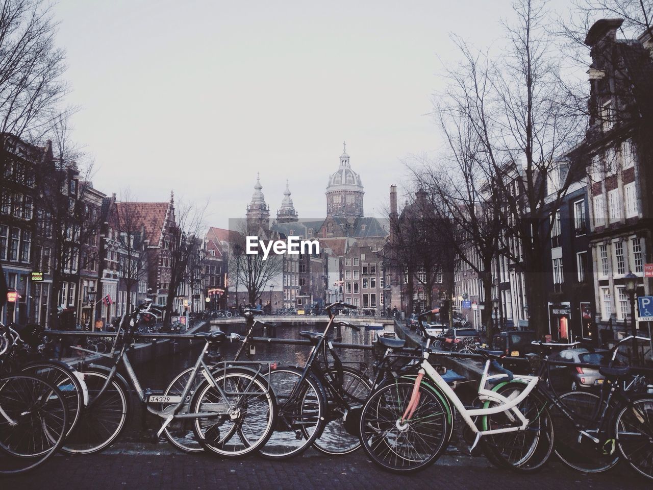 Bicycles parked on footbridge in a city