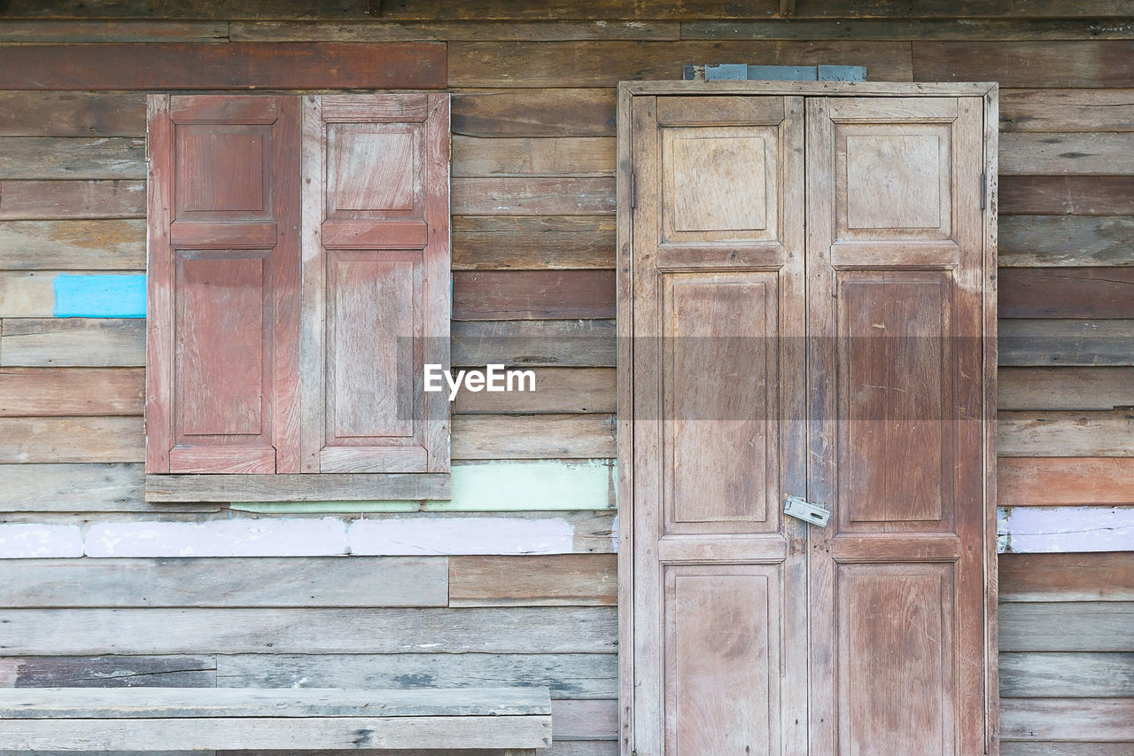 CLOSED WOODEN DOOR OF BUILDING