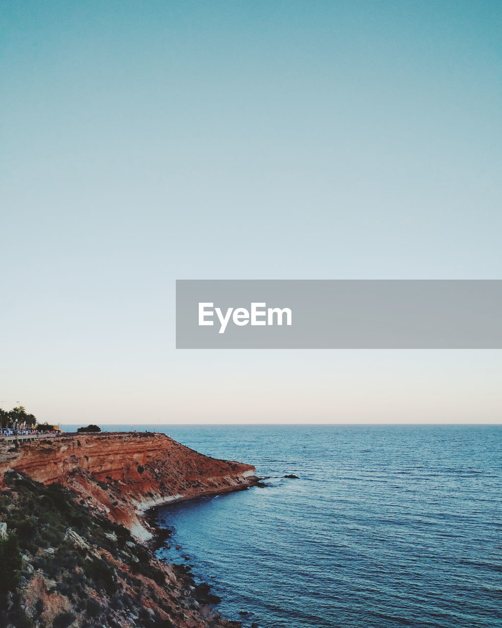 Scenic view of coastline against clear sky