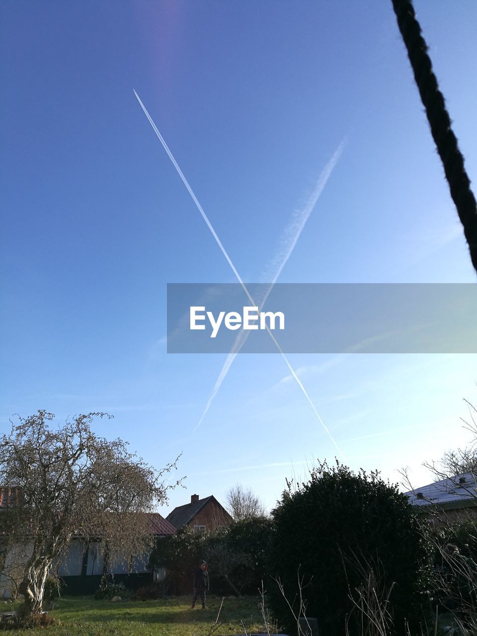 LOW ANGLE VIEW OF VAPOR TRAILS AGAINST SKY