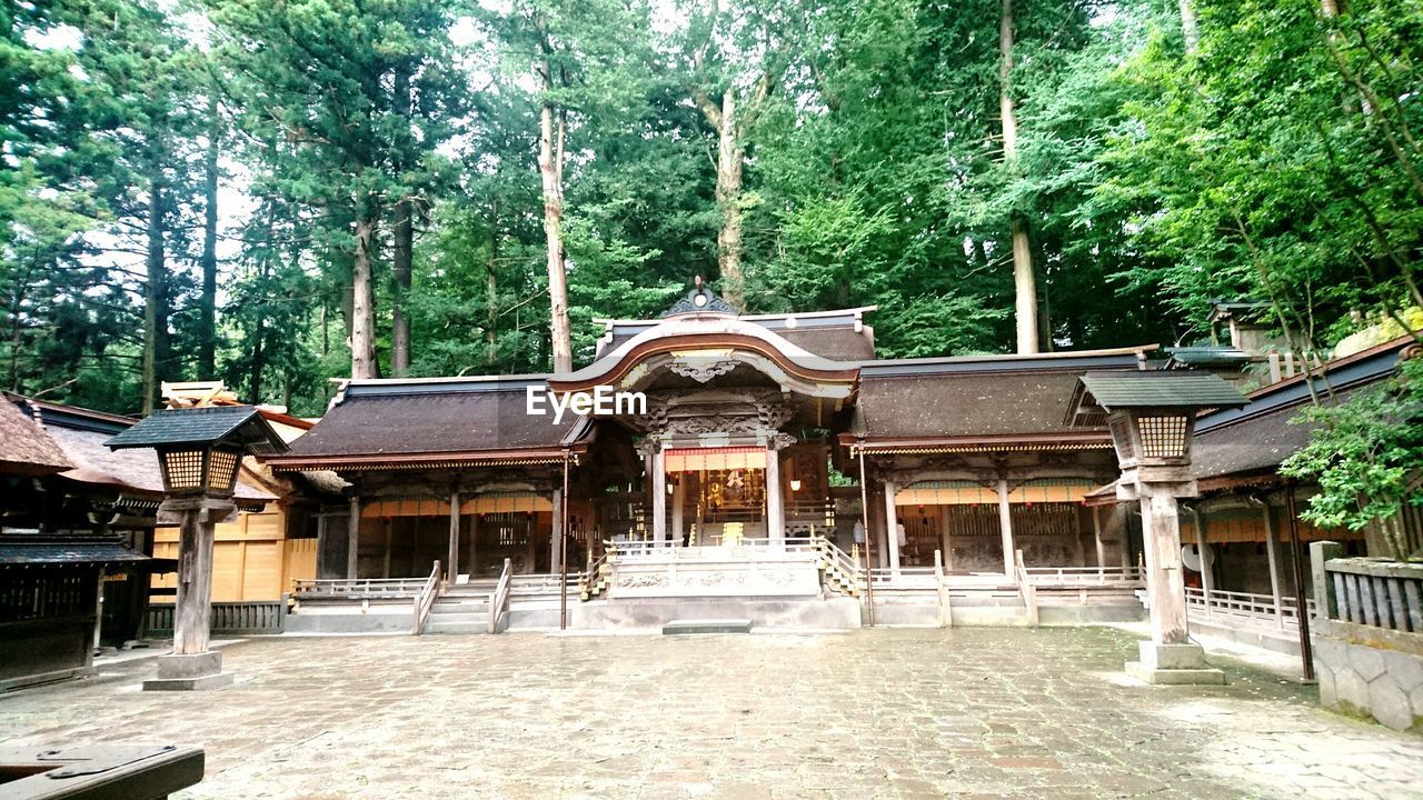 BUILT STRUCTURE WITH TREES AGAINST SKY