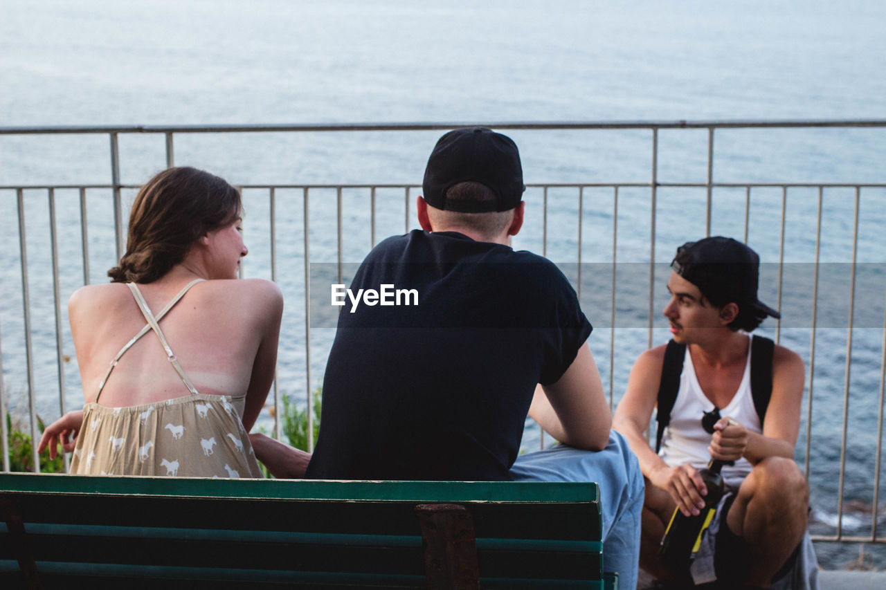 Friends sitting by river