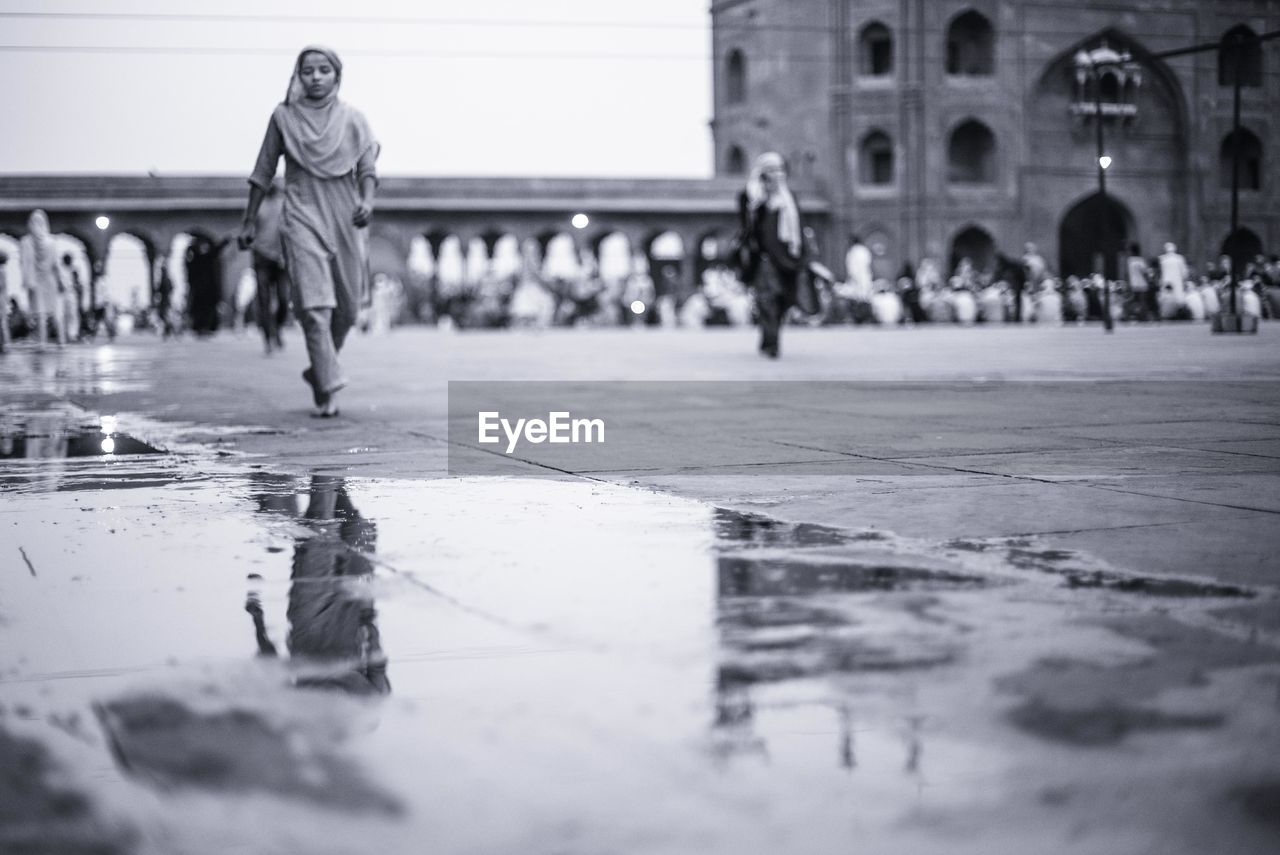 Woman walking on footpath