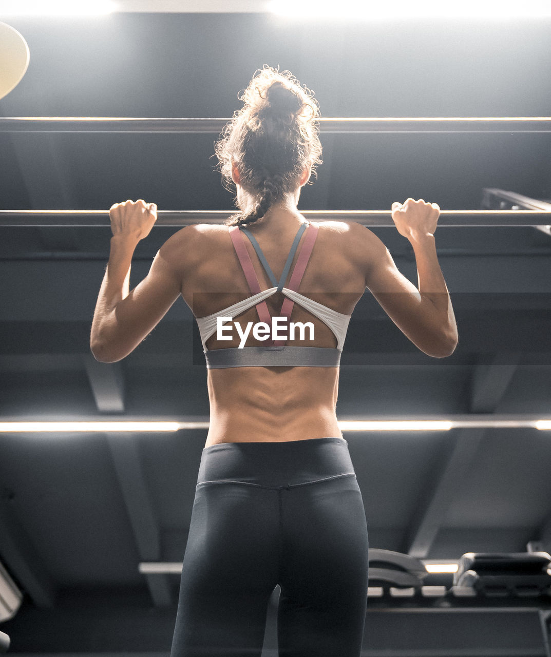 Low angle view of female athlete exercising in gym