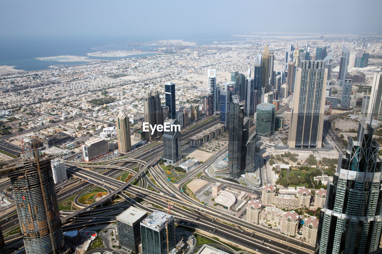 High angle view of modern buildings in city against sky