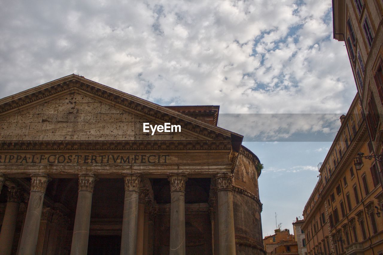 Low angle view of historical building against cloudy sky