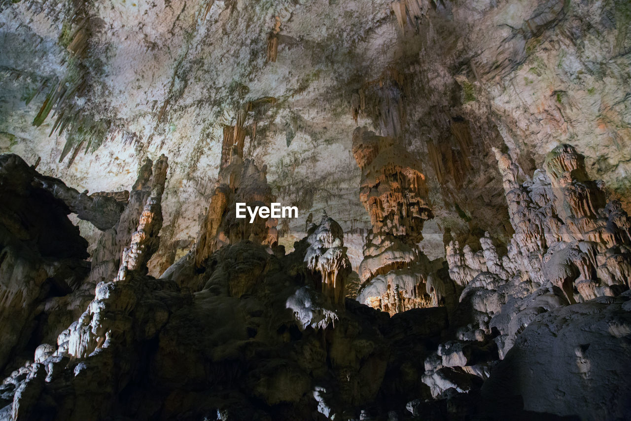 LOW ANGLE VIEW OF ROCK FORMATION IN CAVE