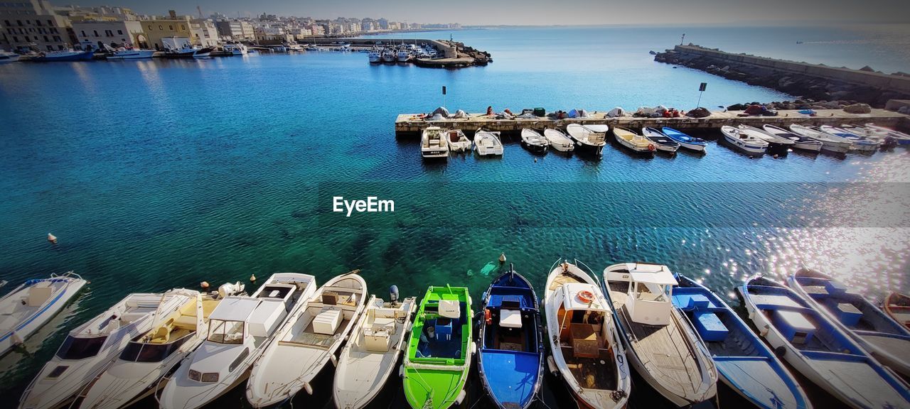 water, nautical vessel, sea, transportation, mode of transportation, vehicle, nature, moored, boat, travel destinations, no people, high angle view, travel, sky, dock, architecture, marina, harbor, scenics - nature, land, tranquility, day, beauty in nature, blue, beach, outdoors, pier, ship, watercraft, building exterior, tourism, tranquil scene, ocean, bay, city, idyllic, built structure