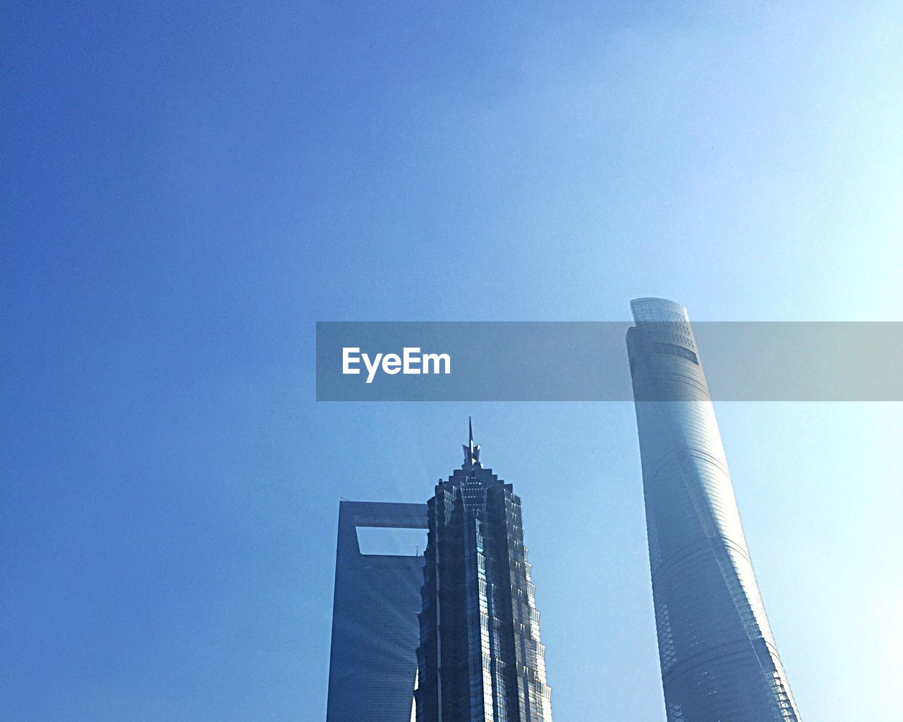 Tall buildings against clear blue sky