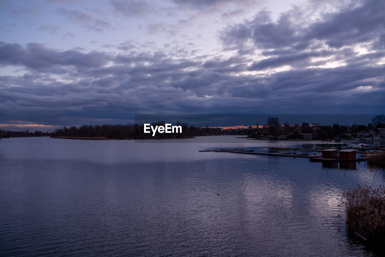 LAKE BY CITY AGAINST SKY